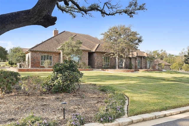 english style home with a front lawn