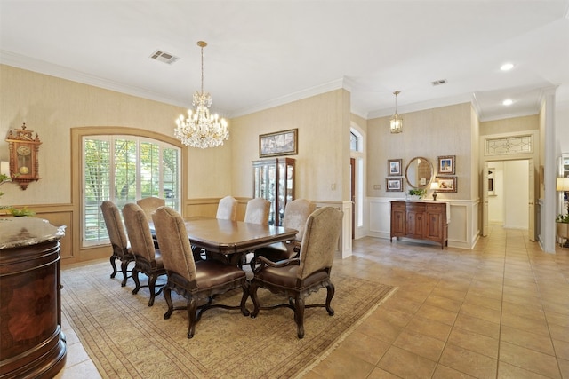 dining area with a chandelier, crown molding, and light tile patterned flooring