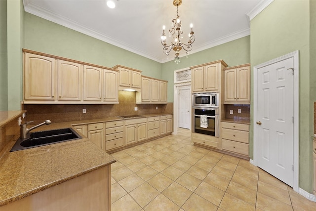 kitchen featuring light brown cabinetry, hanging light fixtures, a notable chandelier, and appliances with stainless steel finishes