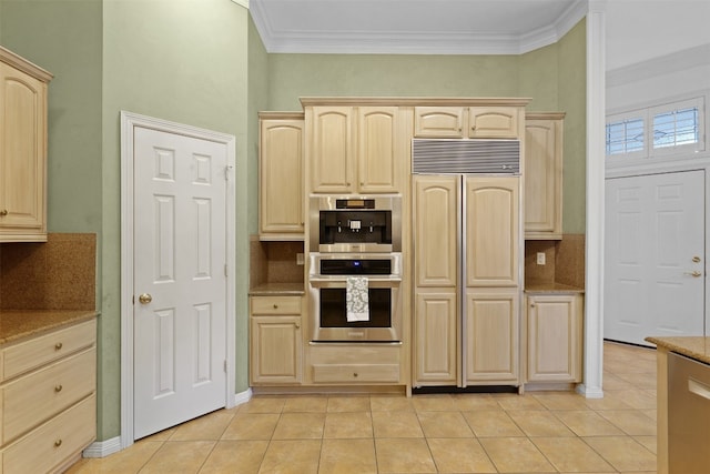 kitchen featuring paneled built in fridge, light brown cabinetry, tasteful backsplash, light tile patterned flooring, and stainless steel double oven