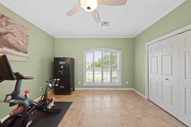 exercise room featuring crown molding, light tile patterned flooring, and ceiling fan