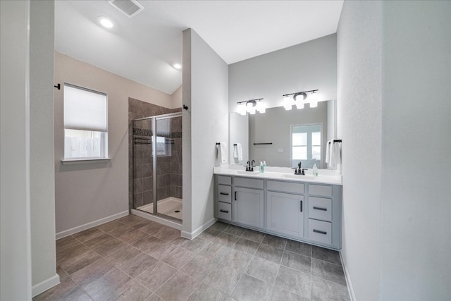 bathroom featuring vanity and a shower with door