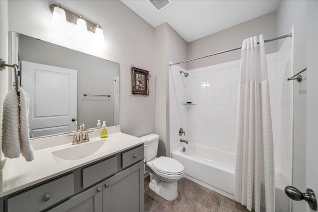 full bathroom with vanity, shower / bath combo, and toilet