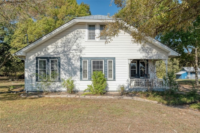 view of property exterior featuring a lawn and covered porch