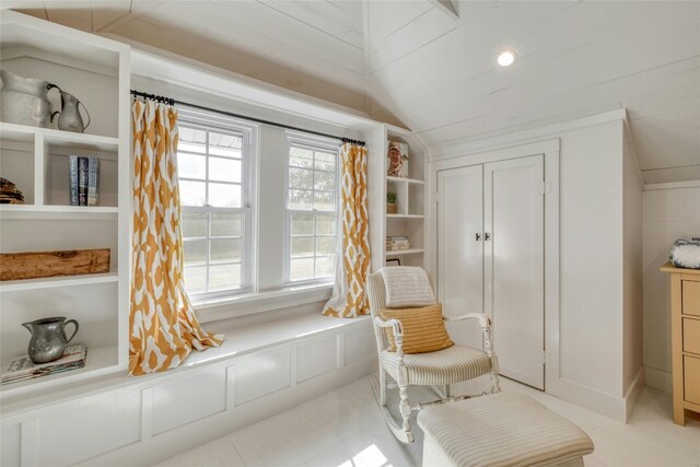 sitting room featuring vaulted ceiling