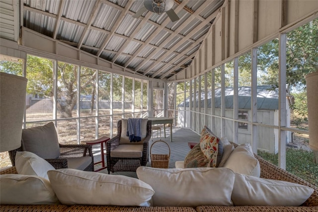 sunroom / solarium with ceiling fan and lofted ceiling