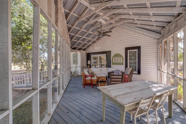 unfurnished sunroom featuring ceiling fan and lofted ceiling