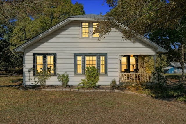 view of home's exterior featuring a lawn and covered porch