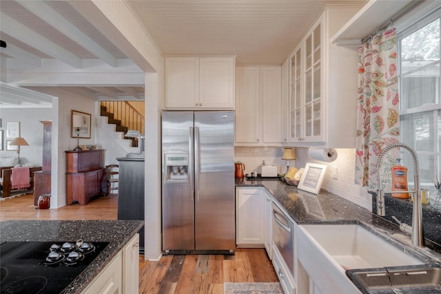 kitchen featuring white cabinets, appliances with stainless steel finishes, light hardwood / wood-style floors, and sink