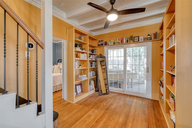 interior space with ceiling fan, beam ceiling, light wood-type flooring, and ornamental molding