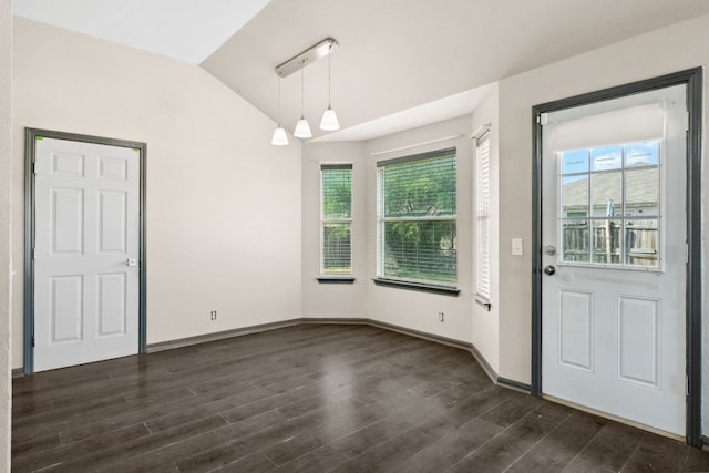 unfurnished dining area featuring plenty of natural light, lofted ceiling, and dark wood-type flooring