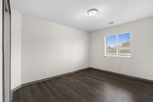 spare room with dark hardwood / wood-style flooring