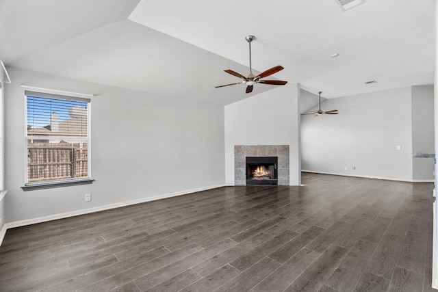 unfurnished living room featuring a fireplace, dark hardwood / wood-style flooring, and high vaulted ceiling