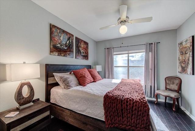 bedroom with dark hardwood / wood-style flooring and ceiling fan