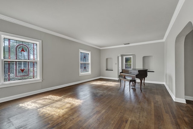 unfurnished dining area featuring dark hardwood / wood-style floors and crown molding