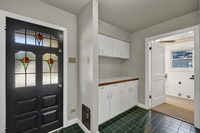 mudroom featuring dark tile patterned flooring