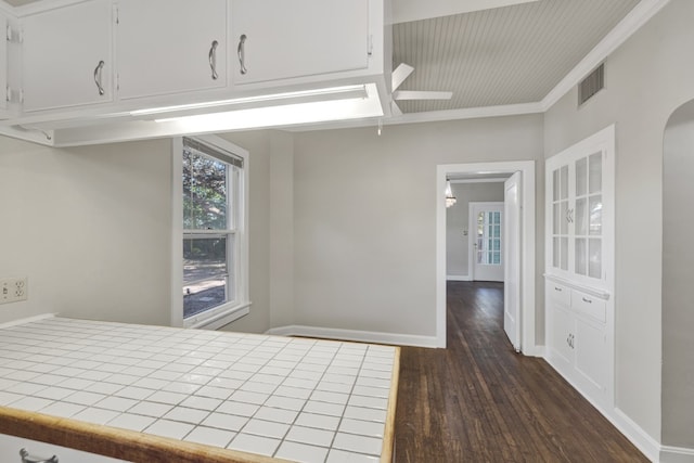 unfurnished bedroom featuring dark hardwood / wood-style floors and ornamental molding