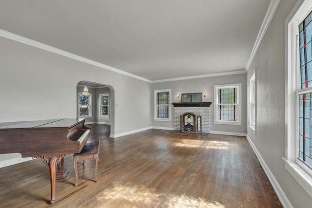 living room with a fireplace, crown molding, and dark wood-type flooring