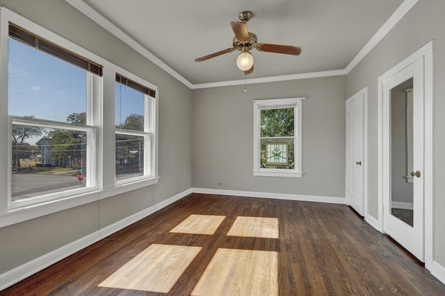 empty room with ceiling fan, ornamental molding, and dark wood-type flooring