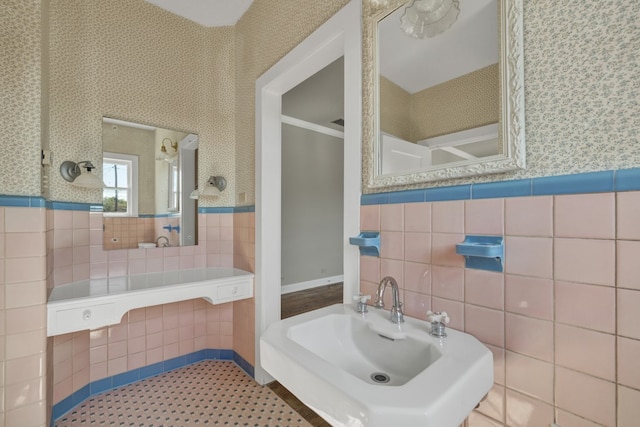 bathroom featuring sink and tile walls