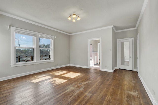 spare room featuring ornamental molding and dark wood-type flooring