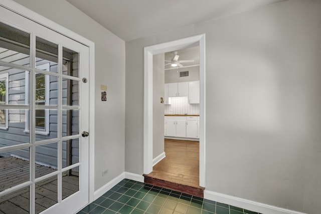 interior space featuring dark tile patterned flooring and ceiling fan