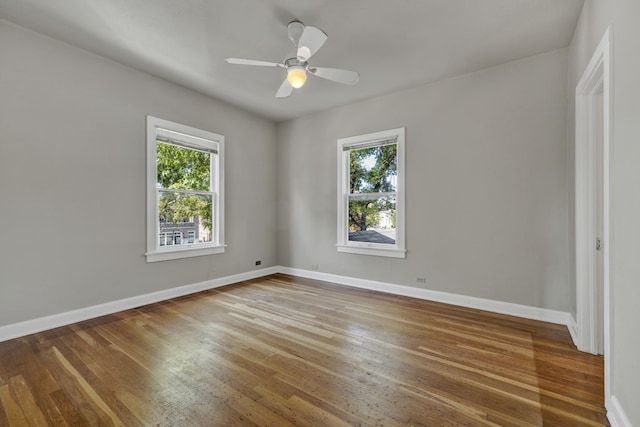 spare room with hardwood / wood-style floors, plenty of natural light, and ceiling fan