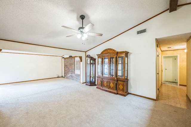 811 Ross Cir, Lockhart, TX 78644 - empty room with lofted ceiling, a textured ceiling, carpet flooring, ceiling fan, and baseboards