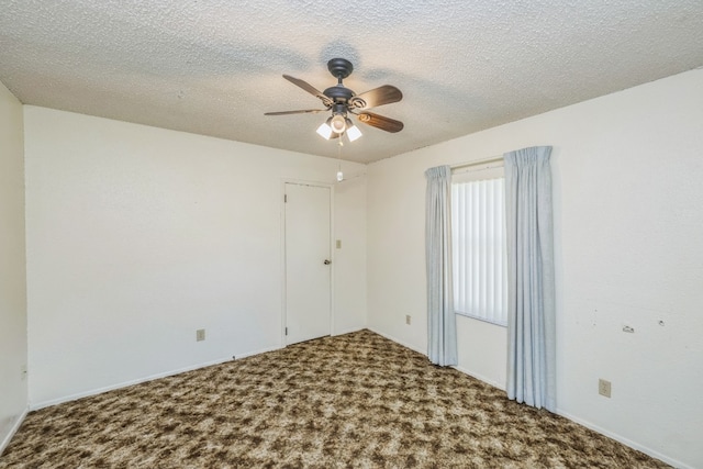 carpeted empty room featuring a textured ceiling and ceiling fan