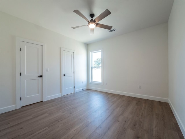 interior space with ceiling fan and dark hardwood / wood-style floors