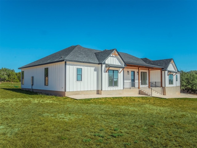 rear view of property featuring a yard