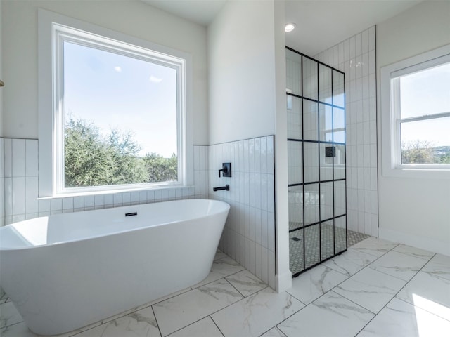 bathroom with plenty of natural light and independent shower and bath