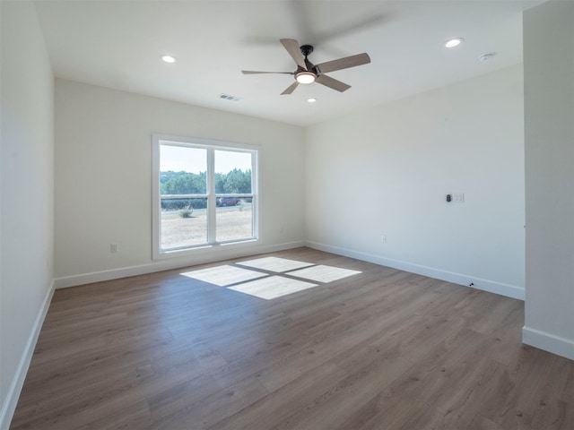 empty room featuring ceiling fan and dark wood-type flooring