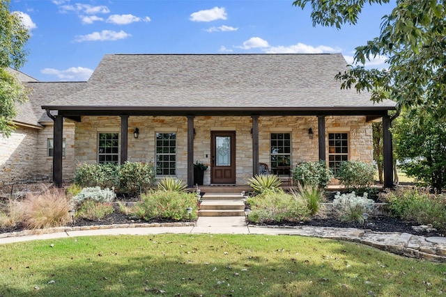 view of front of property with a porch and a front lawn