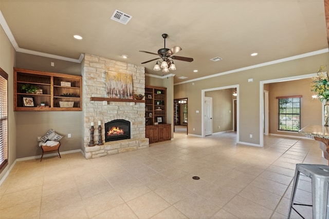 living room featuring light tile patterned floors, a stone fireplace, ceiling fan, and ornamental molding