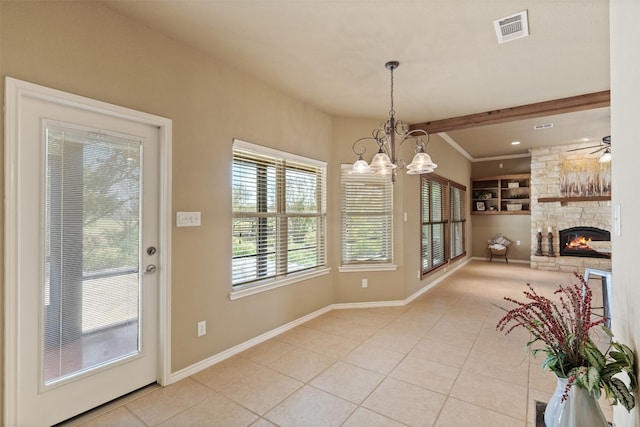 dining area with ceiling fan with notable chandelier, beam ceiling, light tile patterned floors, and a fireplace