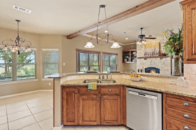 kitchen featuring beam ceiling, sink, stainless steel dishwasher, a fireplace, and ceiling fan with notable chandelier