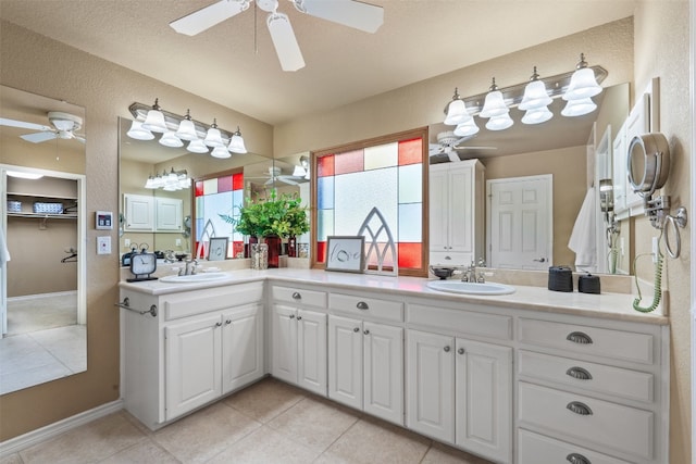 bathroom featuring tile patterned floors, vanity, and a textured ceiling