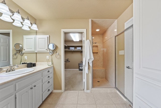 bathroom with tile patterned floors, a textured ceiling, and walk in shower