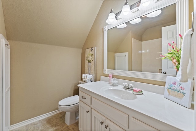 bathroom with tile patterned floors, vanity, toilet, and vaulted ceiling