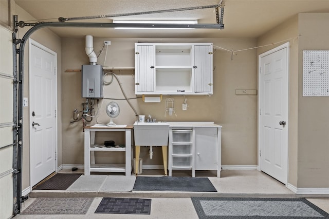 kitchen featuring tankless water heater and sink