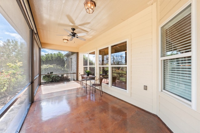 unfurnished sunroom featuring ceiling fan