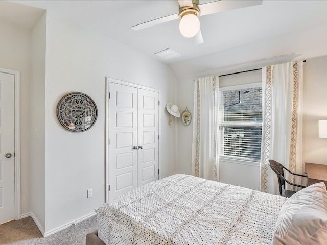 bedroom with carpet flooring, a closet, vaulted ceiling, and ceiling fan