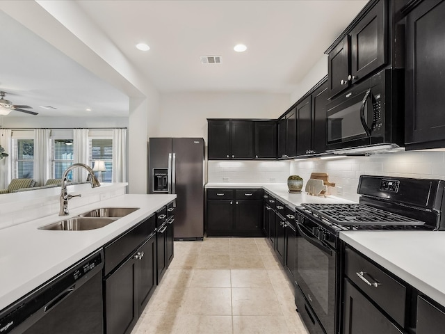 kitchen featuring ceiling fan, sink, decorative backsplash, light tile patterned flooring, and black appliances