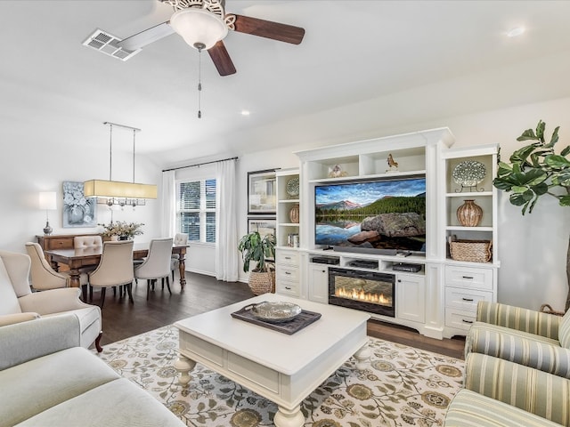 living room featuring hardwood / wood-style floors and ceiling fan