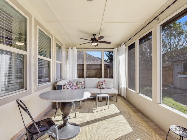 sunroom featuring ceiling fan