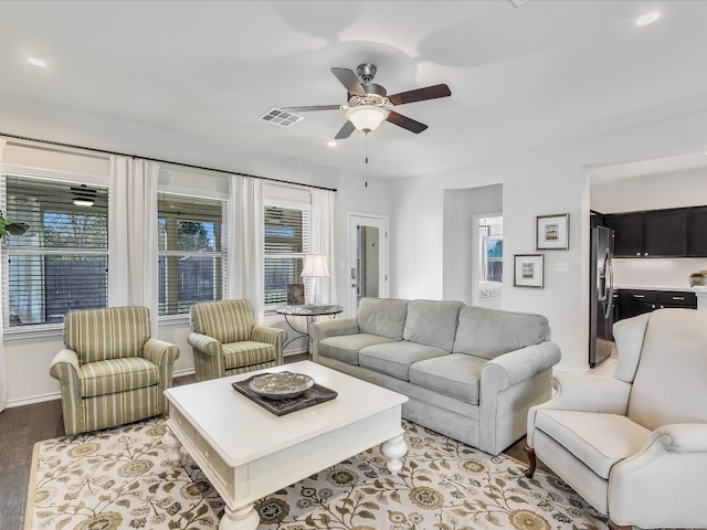 living room with ceiling fan and light hardwood / wood-style floors