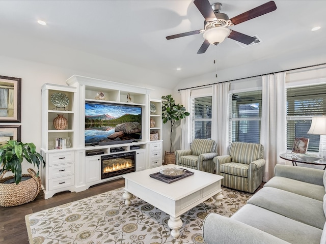 living room featuring dark hardwood / wood-style flooring and ceiling fan