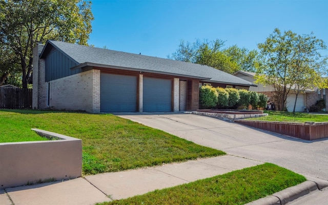 view of front of property featuring a garage and a front lawn