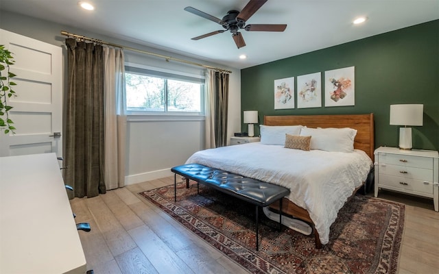 bedroom with ceiling fan and light hardwood / wood-style floors